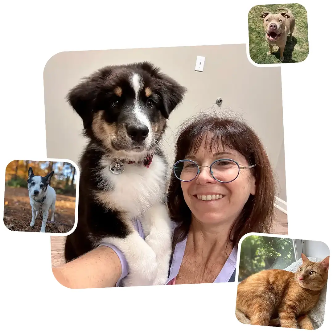 Smiling woman wearing glasses posing with a fluffy black-and-white puppy for a selfie.